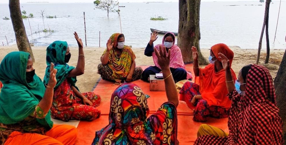 Photo: Adult female’s VSLA group named Peyara (Guava) from Noyapara village, Dampara union of Kishoreganj during a team voting for box keeper. Photo: Razu Ahmed. September 2020.
